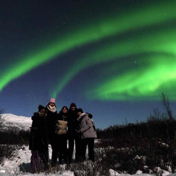 Photo of exchange students and the Northern Lights
