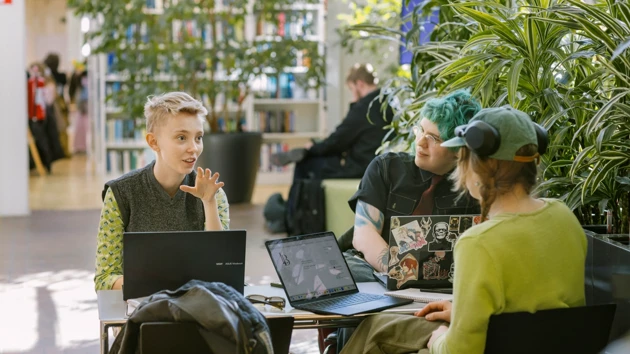 Students in conversation in a cosy study space.