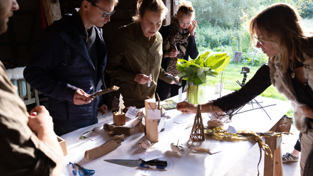Stakeholders using tangibles collected from a barn in the forest to conduct a stakeholder mapping exercise. The library-to-be is situated in Stenderup Midtskov, in Kolding, Denmark, and is part of the Fusilli project.