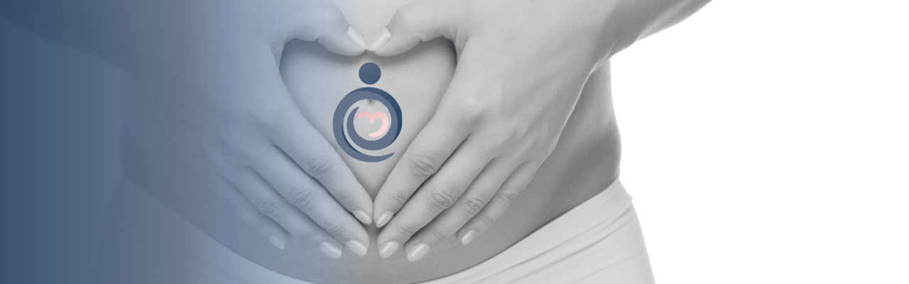 Hands forming a heart on the stomach.