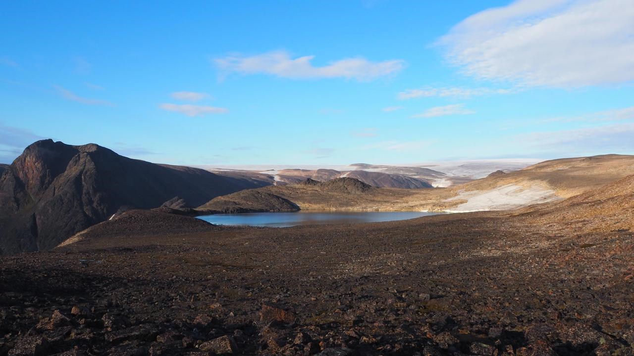 Picture of lake and surrounding barren landscape and mountains