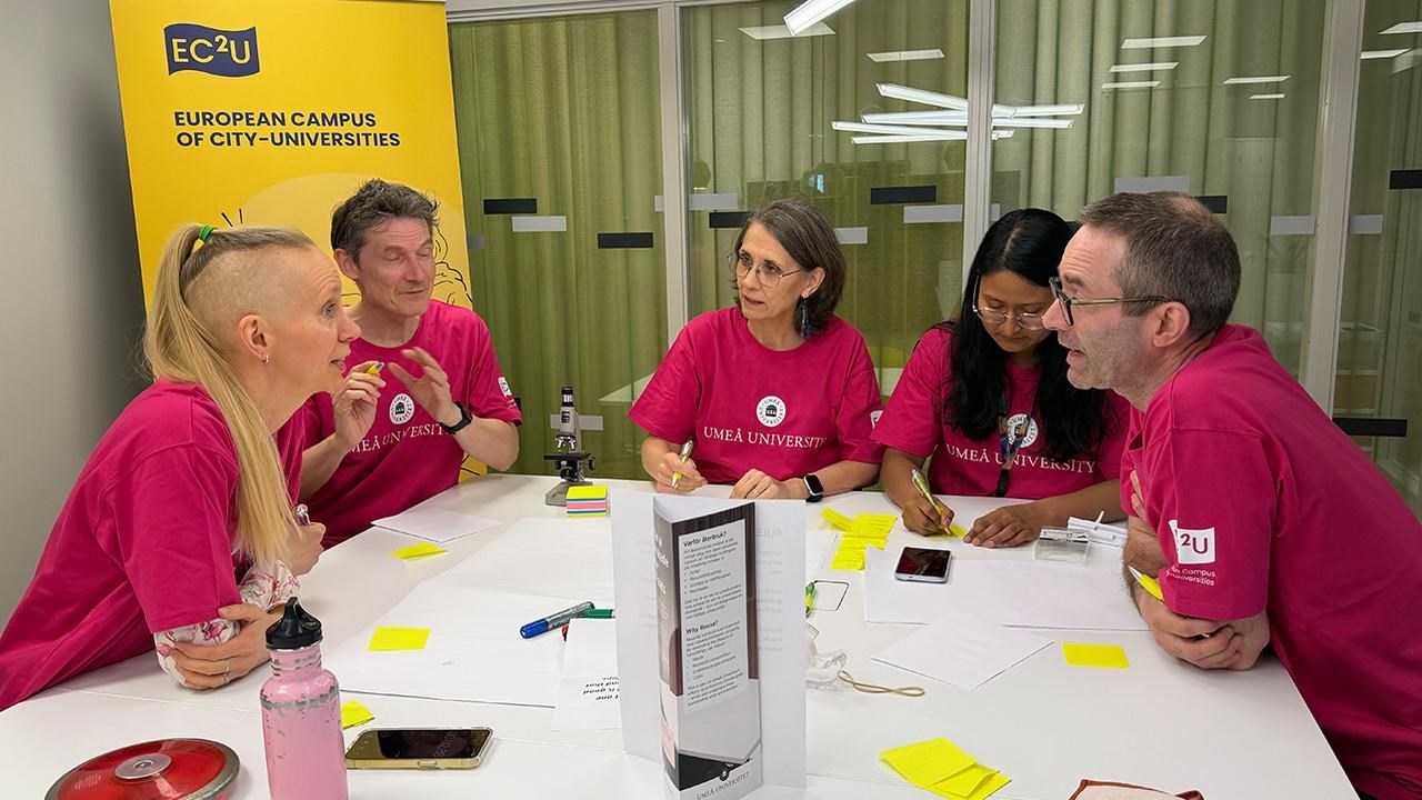 A group of people sitting around a table.