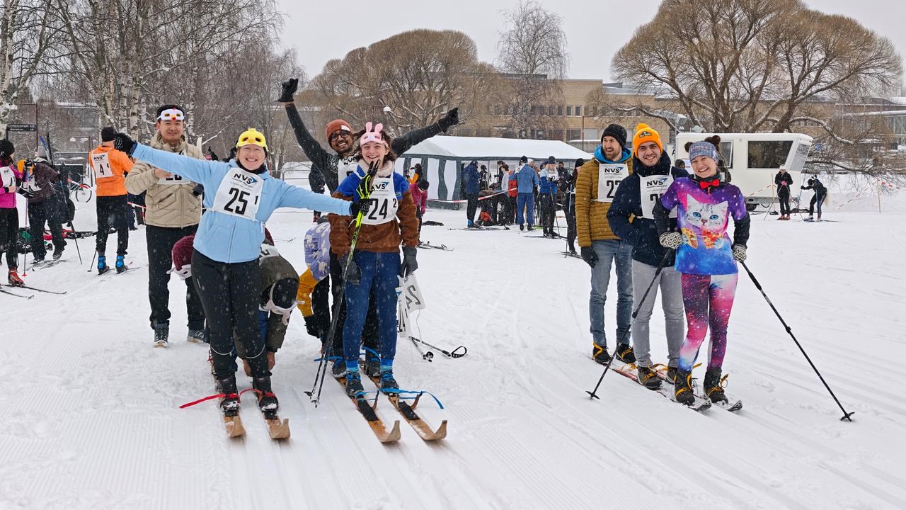 Three teams of skiers are preparing for a ski race in the battleship category - four skiers on one pair of skis