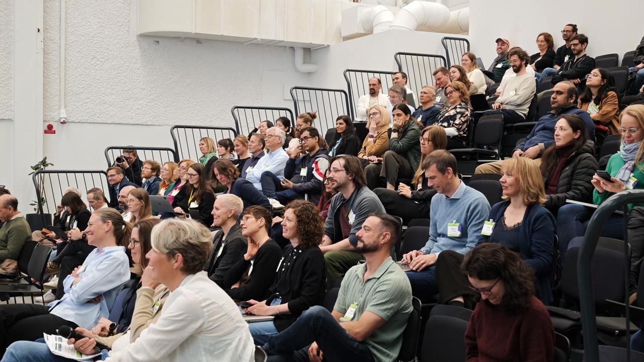 A large group of people sitting in a lecture hall at the scientific conference