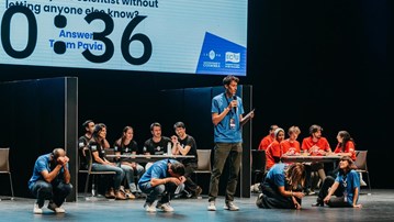 A man standing on a stage with a microphone.