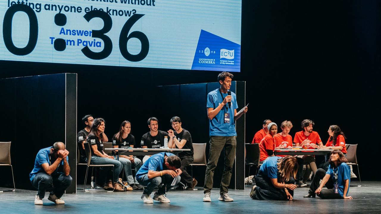 A man standing on a stage with a microphone.