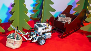 EV3 robot with raindeer horns delivers christmas presents.