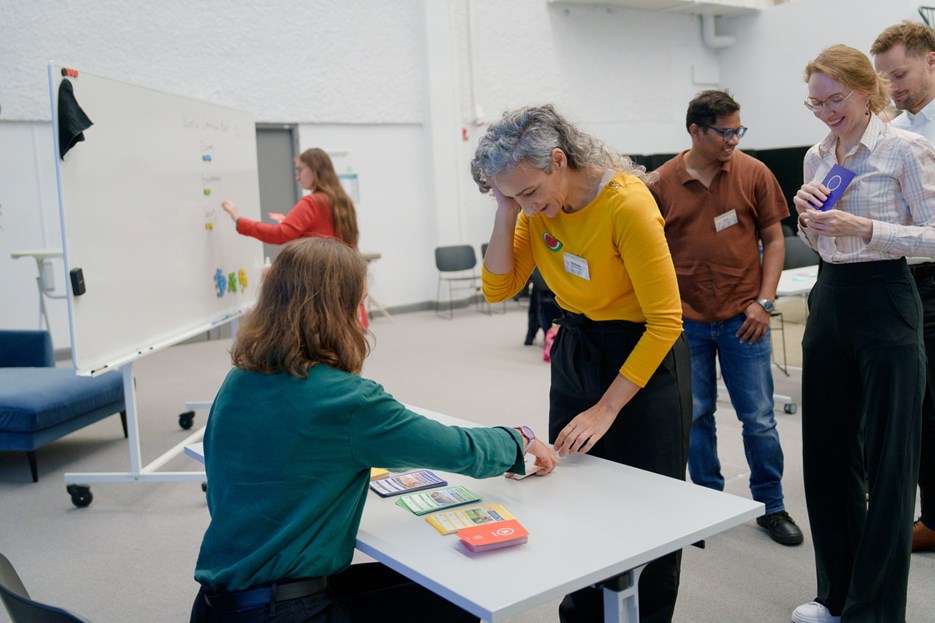 Players wait for their turn to carry out their projects, which will affect the world economy and environment.