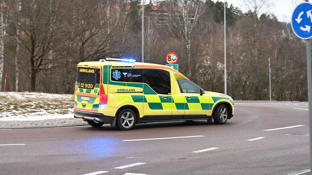 Ambulans med bl&aring;ljus i en rondell