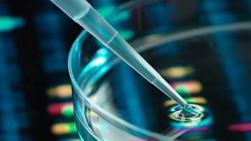 Pipette adding sample to petri dish with DNA profiles in background