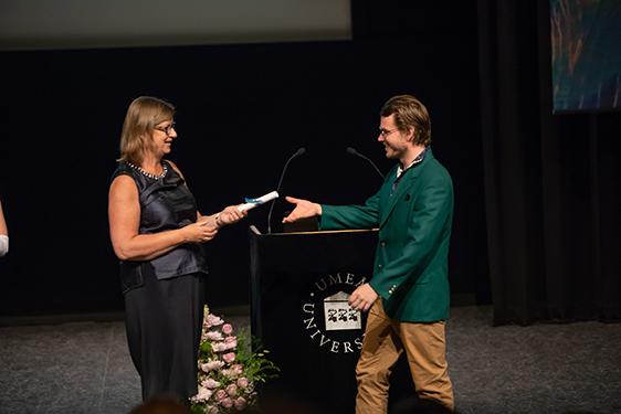 Picture of student Andrew Nesbit, receiving a diploma on stage