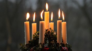 Close-up of a Lucia crown with lit candles