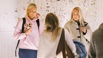Students talking to each other at the Teacher Education Building. 
