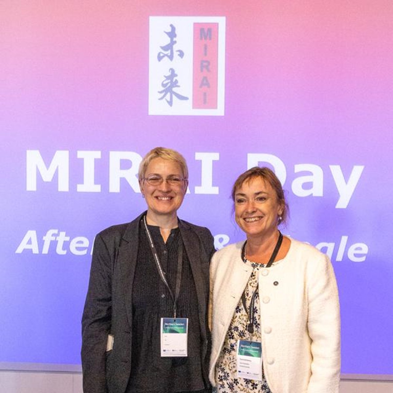 Two vice-chancellors standing next to each other on a stage.