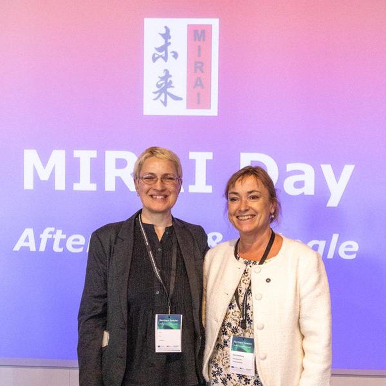 Two vice-chancellors standing next to each other on a stage.