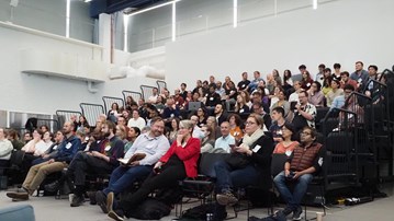 A large group of people sitting in a room during the scientific conference