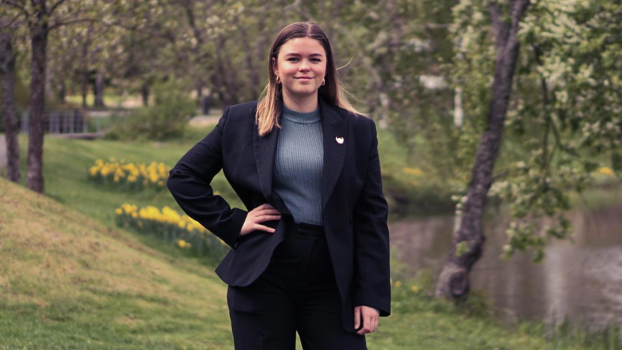 En kvinna i svart kostym st&aring;r framf&ouml;r en flod.