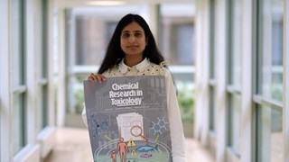 Farina holding a poster