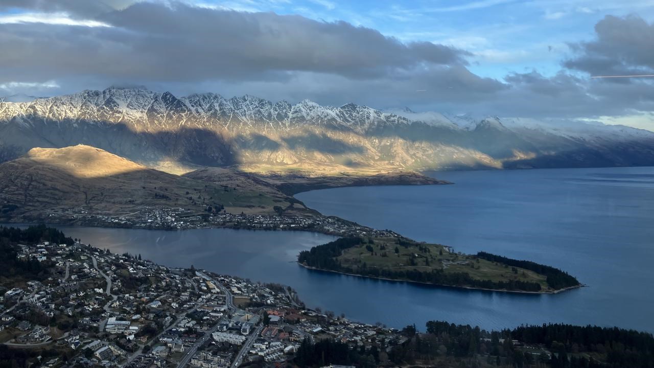 Landskapsbild med berg och vatten i soluppgång.