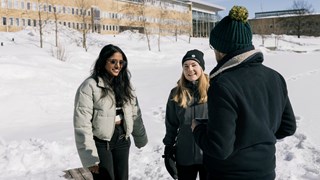 International students by the campus pond in the wintertime.