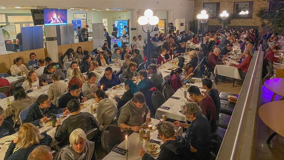 A large group of people sitting at tables during the conference dinner