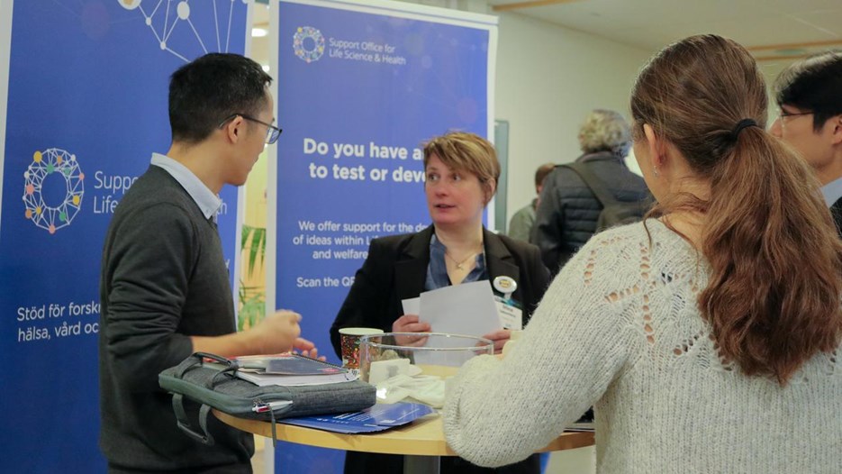 A group of people standing around a table.