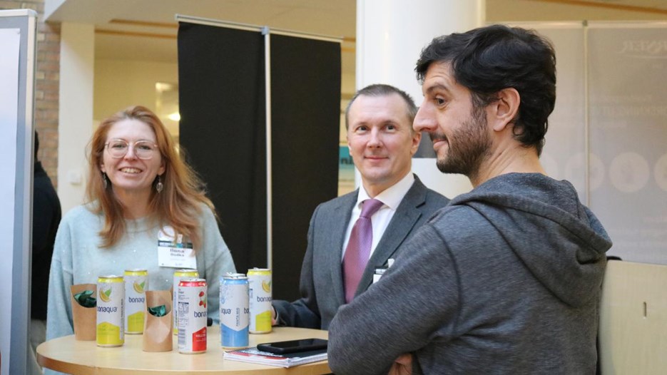 A group of people standing around a table.
