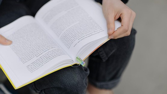 Person holding an open book