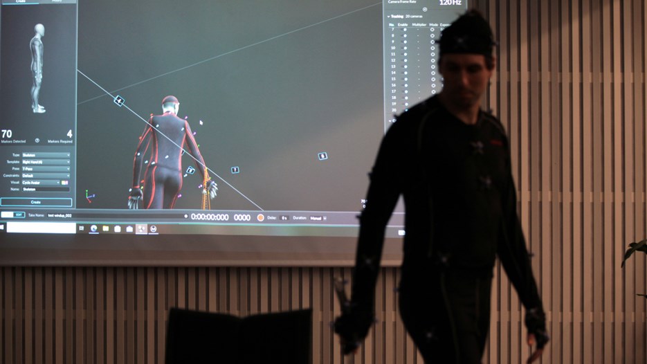 Love Ersare in Motion Capture suit. Screen in background displaying his movements in 3D.
