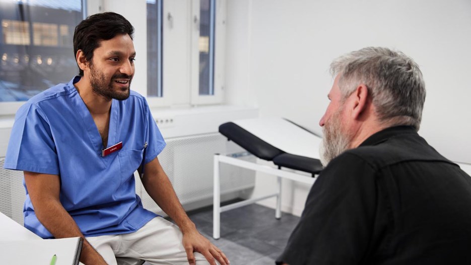 Läkare möter patient i ett undersökningsrum.