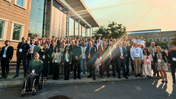 A group of people standing in front of a building at Umeå university.