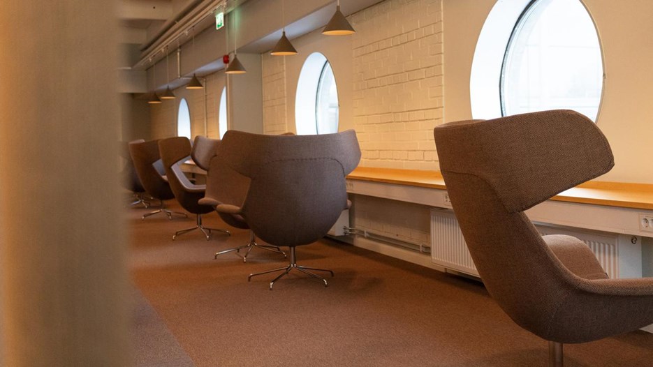 Armchairs in front of the windows.