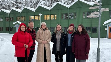En grupp människor som står bredvid varandra i snön.