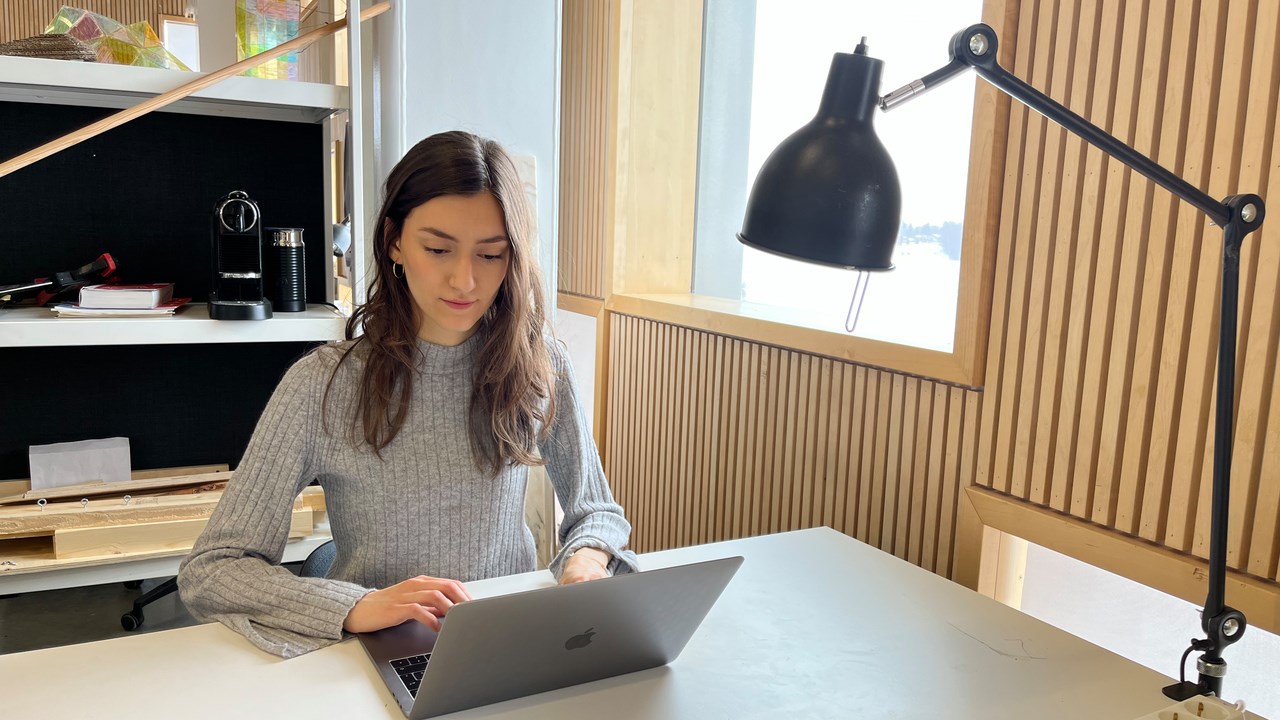 Emma Biondani sitting at her desk at Umeå School of Architecture.