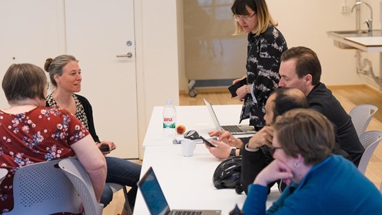Students around table discussing