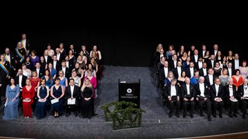 A green background with flowers symbolising the Spring Graduation.