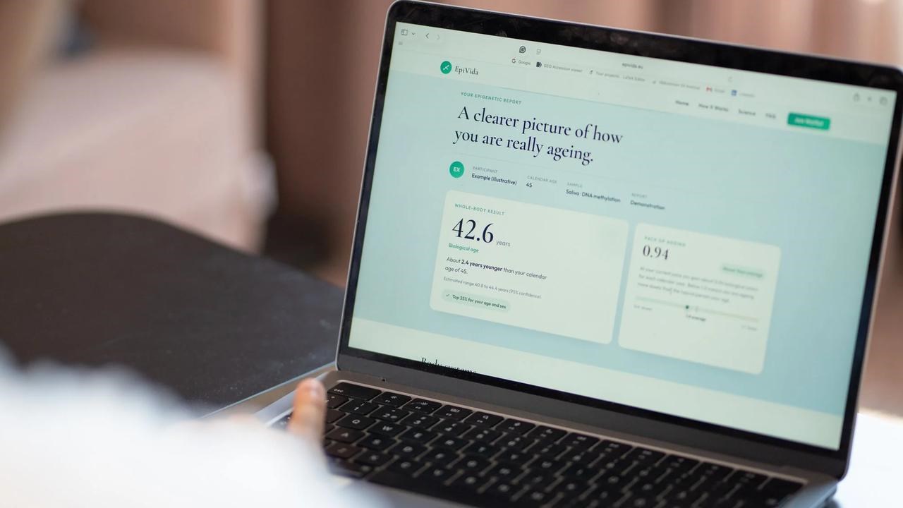 A laptop on a table, on the screen is a calculation of the user's ageing.