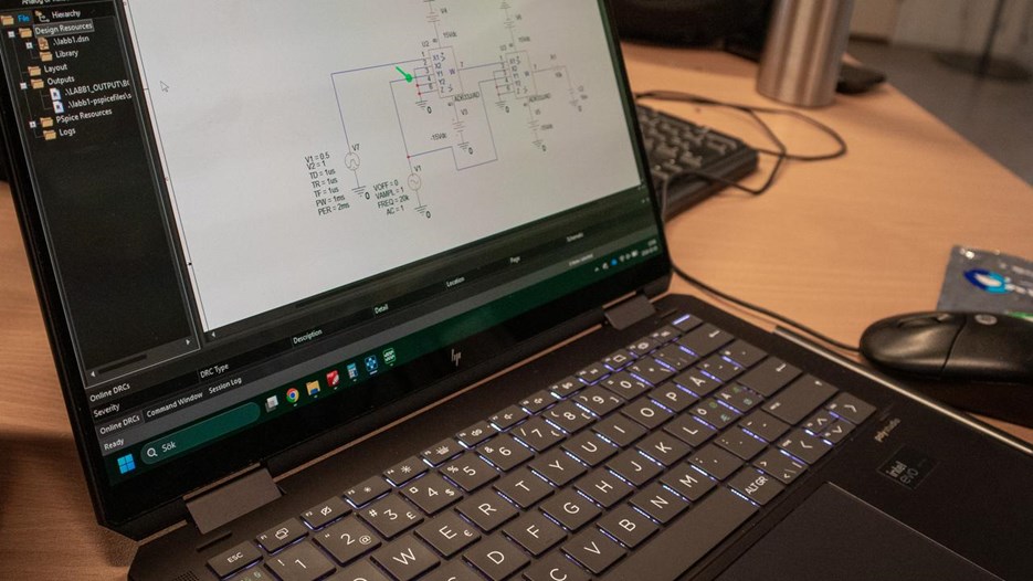 Computer on a table with grafs on it