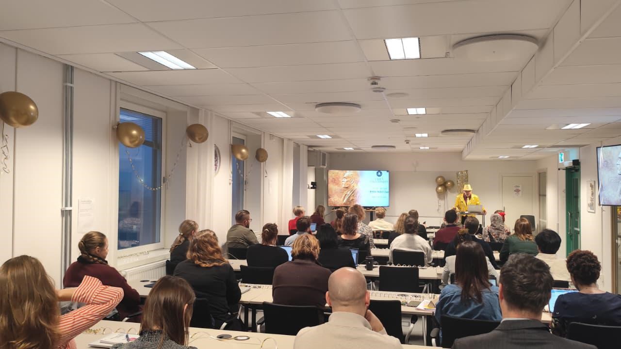 A group of people sitting at tables in a room.