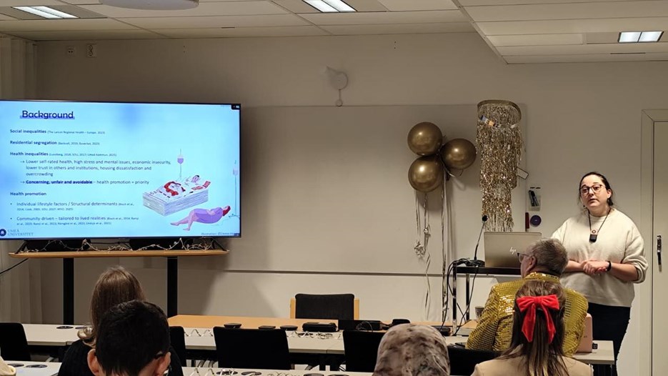 A woman giving a presentation to a group of people.