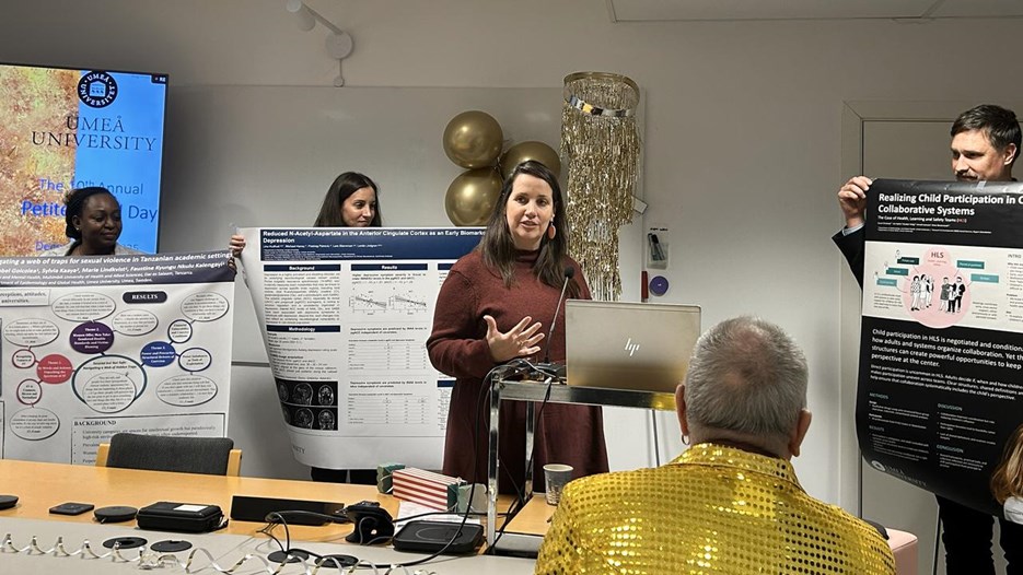 A group of people standing around a table.