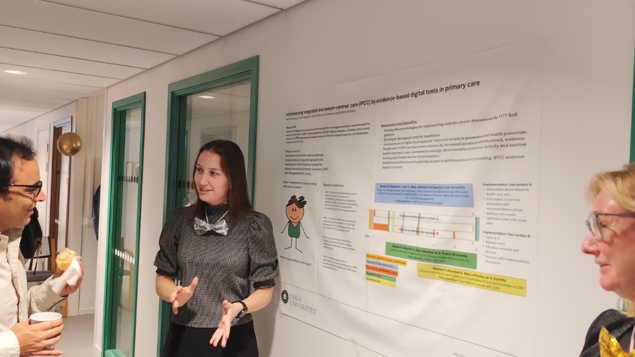 A group of people standing around a white board.