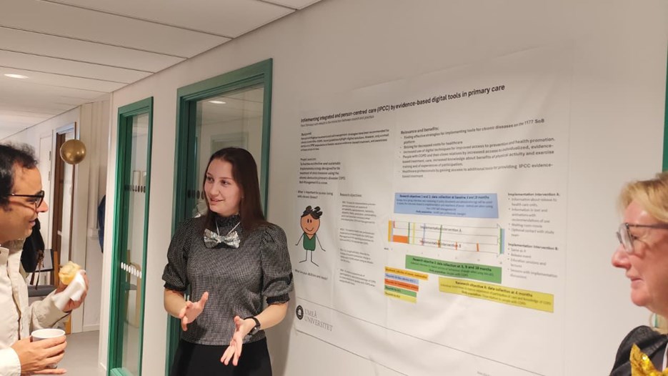 A group of people standing around a white board.