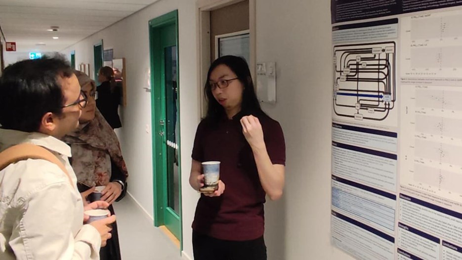 A group of people standing in a hallway.