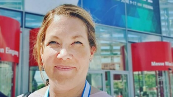 Porträtt av Anneli Enblom Larsson framför byggnad.