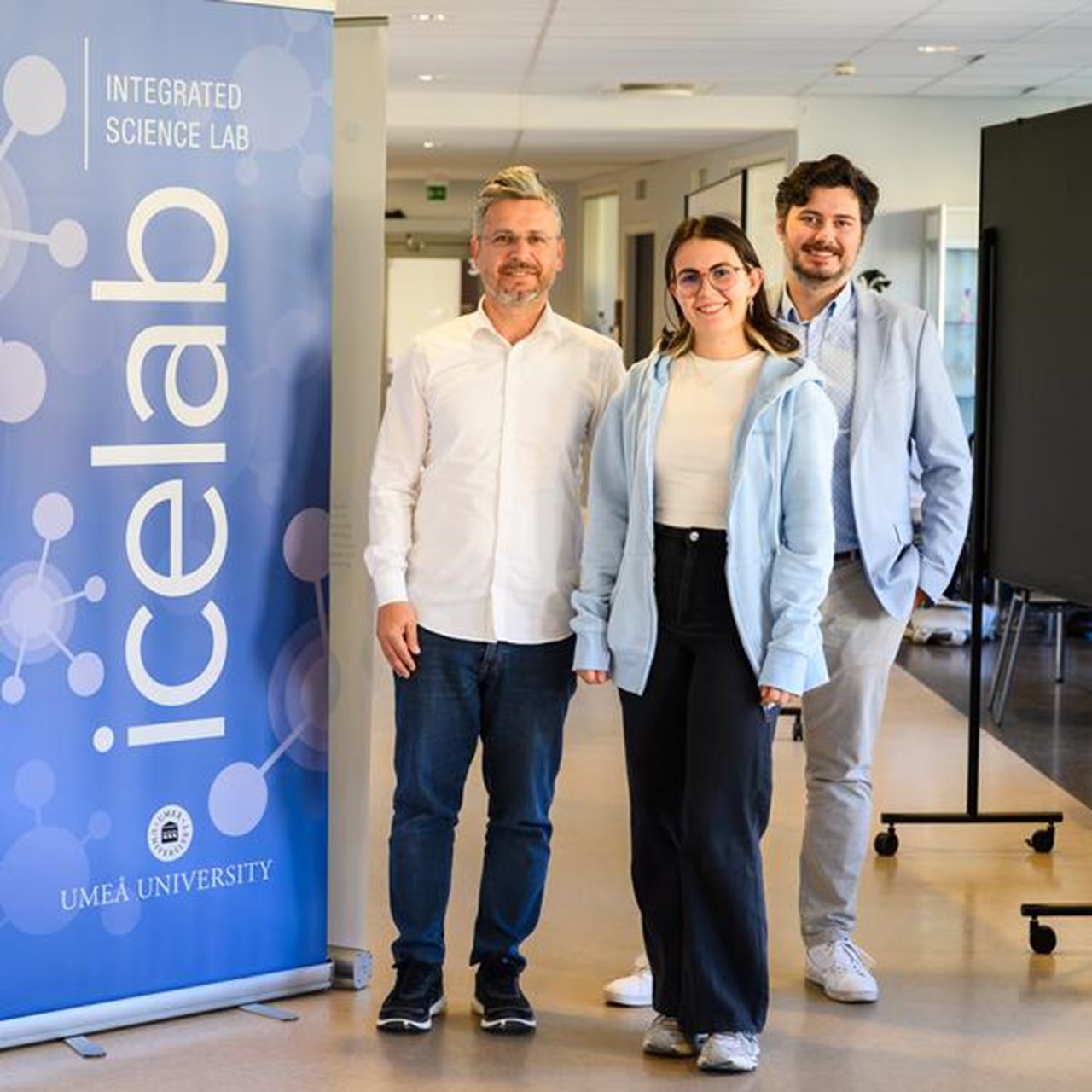 A group of people standing in front of a sign that says icelab.