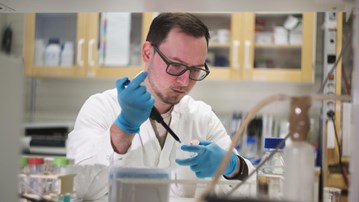 Dmytro Sokol working in a lab