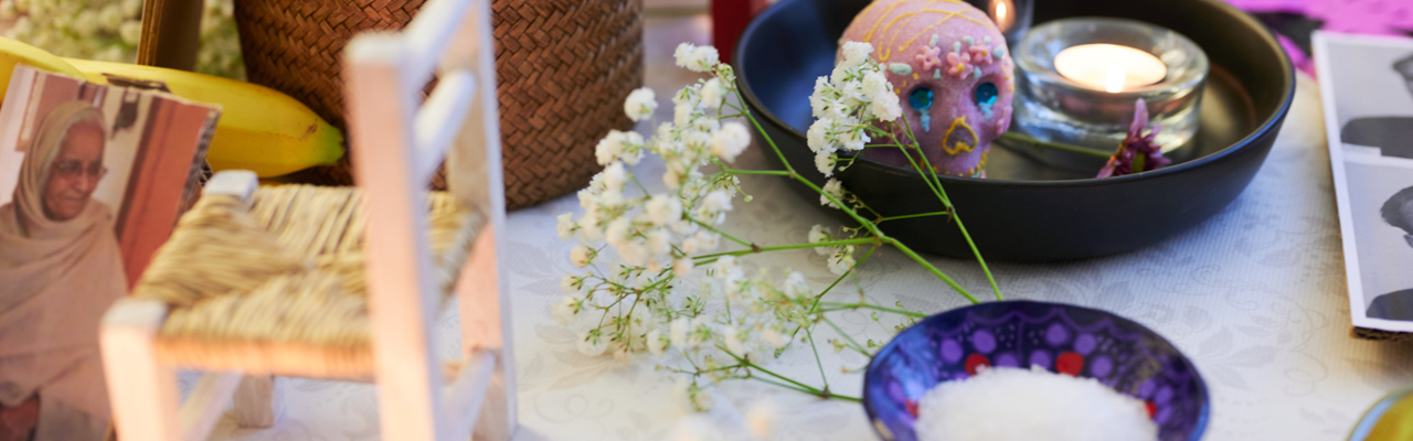 A table topped with a vase filled with flowers.