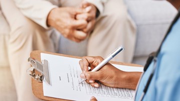 Sjukvårdspersonal intervjuar patient.