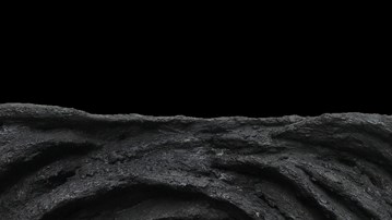 Dark grey clay-like soil and black sky.